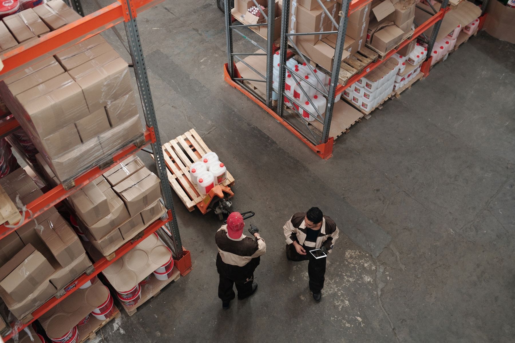 Warehouse staff working together among storage racks